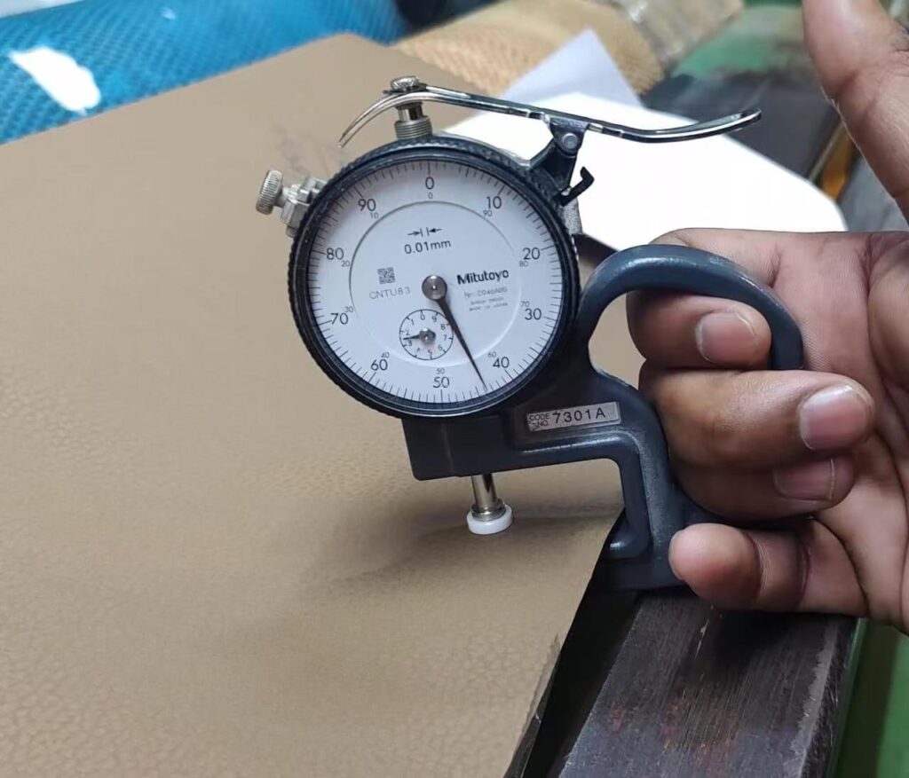 Measure the thickness of artificial leather using a professional thickness gauge.