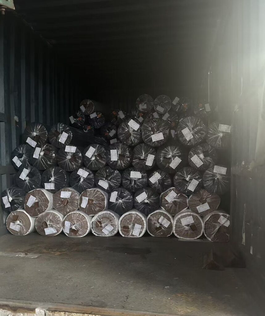 Rolls of synthetic leather await transport inside the cargo compartment.